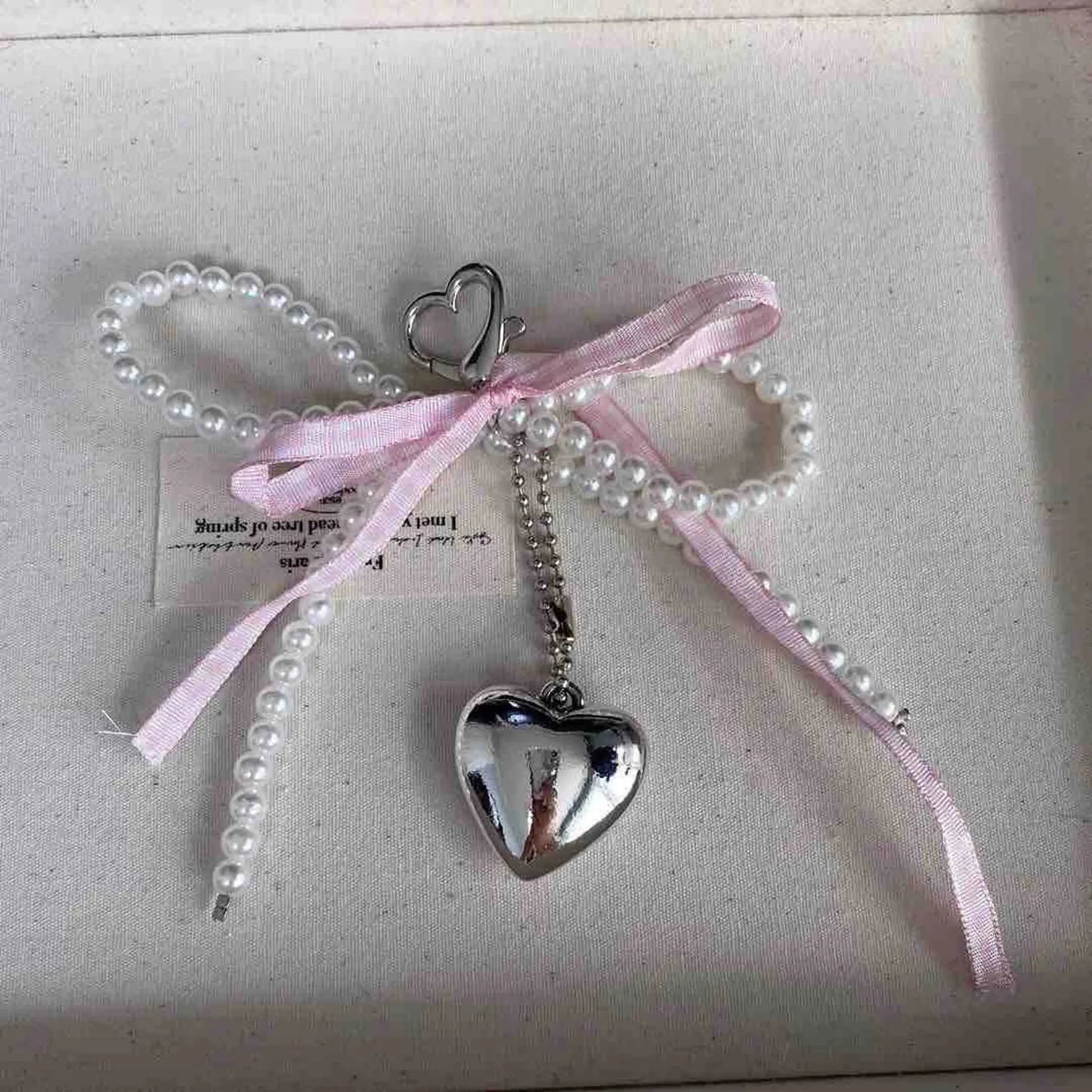 Pearl pendant with pink bow
